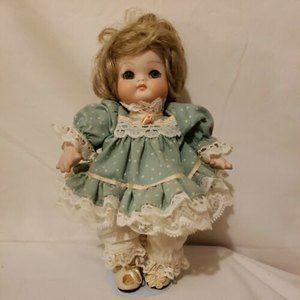 Porcelain Doll 9 Inches Tall Green & Pink Dress 562/1000. Signed w/ a date